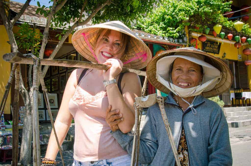Top 5 Historical Sites to Explore in Hoi An Ancient Town smiling female tourist holding a yoke in Hoi An