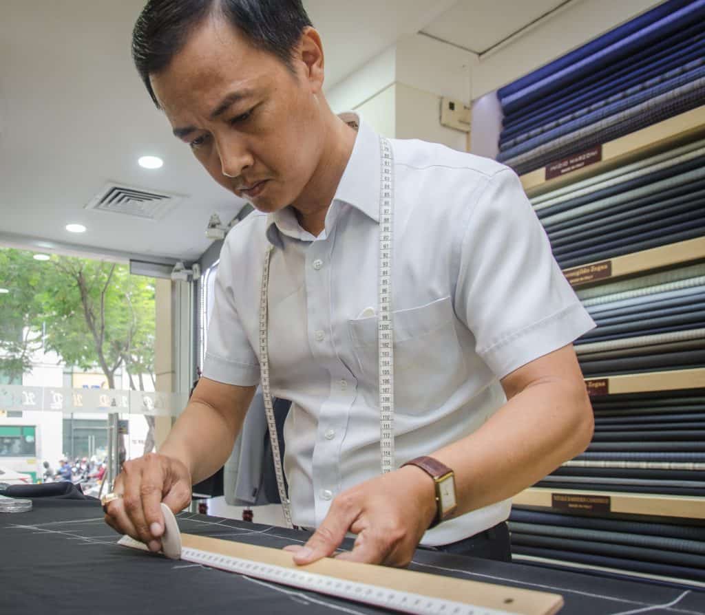 One of the best tailors in Hoi An measuring cloth