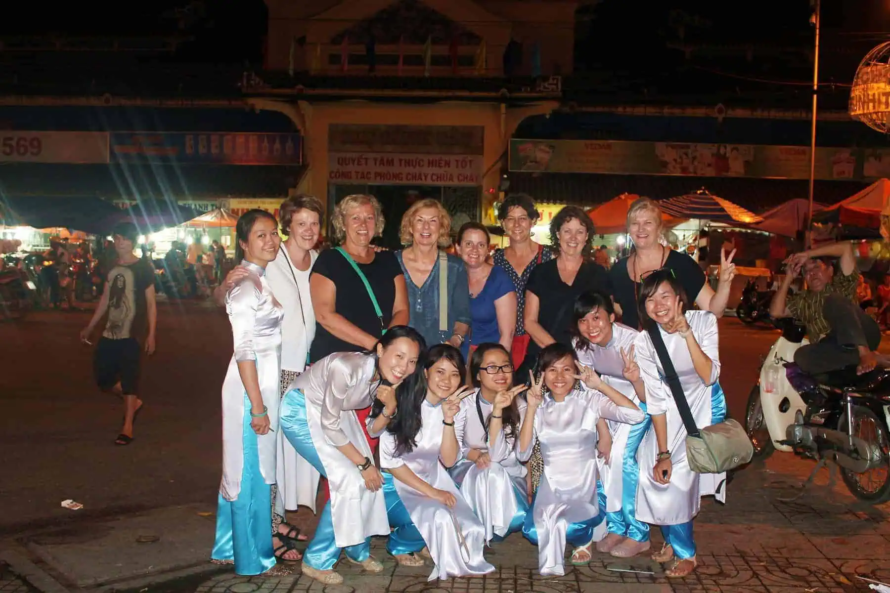 standing in front of the Binh Tay Market